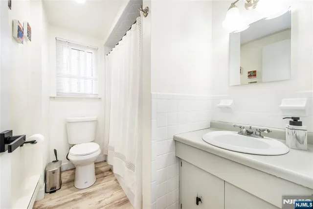 a bathroom with a sink toilet and mirror