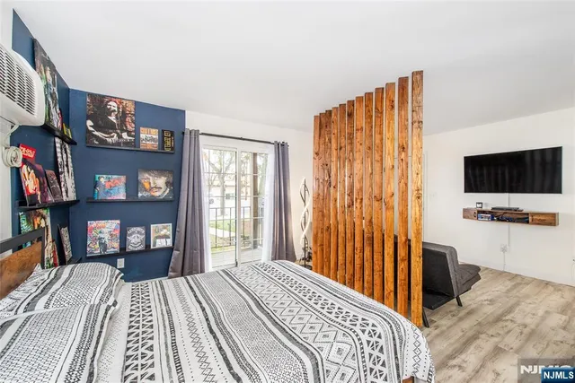 a bedroom with a bed and a flat screen tv