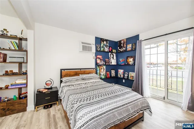 a bedroom with a bed and a large window