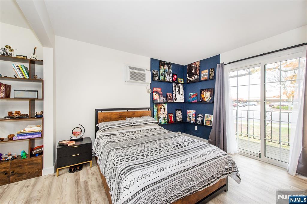 79 Getty Avenue, Unit 4B Clifton, NJ 07011 - Photo 29 of 30 a bedroom with a bed and a large window