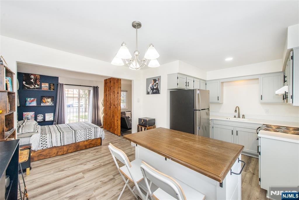 79 Getty Avenue, Unit 4B Clifton, NJ 07011 - Photo 6 of 30 a large kitchen with sink cabinets and stainless steel appliances