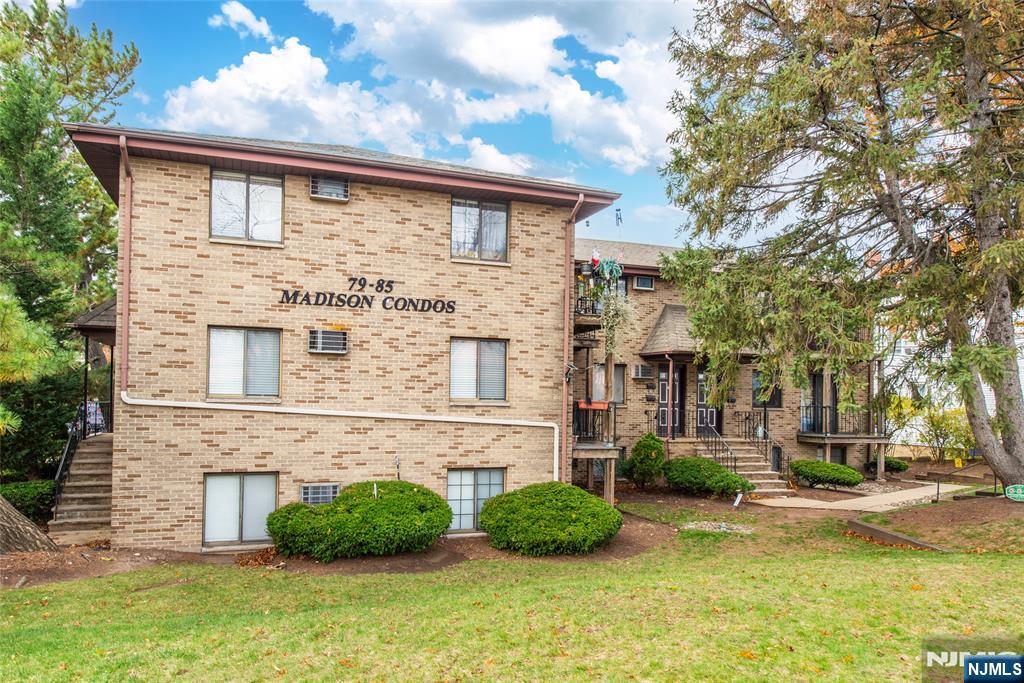 79 Getty Avenue, Unit 4B Clifton, NJ 07011 - Photo 10 of 30 a view of a white house next to a yard with big trees