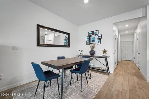 a view of a dining room with furniture and wooden floor