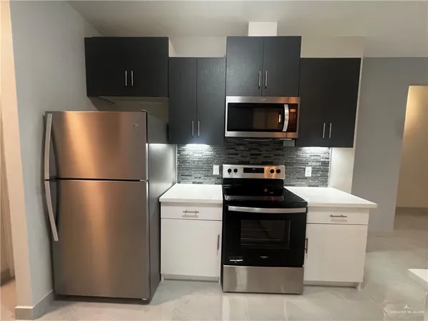 a kitchen with a refrigerator stove and microwave