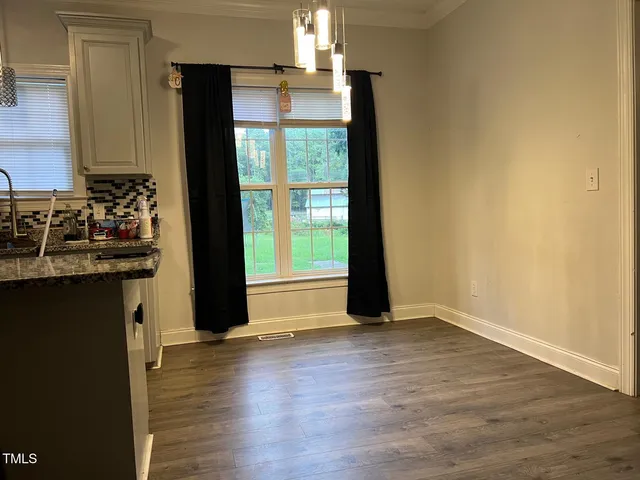 a kitchen with a refrigerator and a stove
