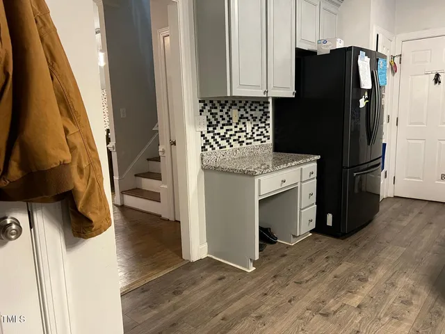 a kitchen with granite countertop a sink stove and cabinets