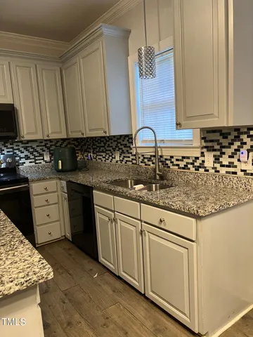 a living room with furniture and a ceiling fan