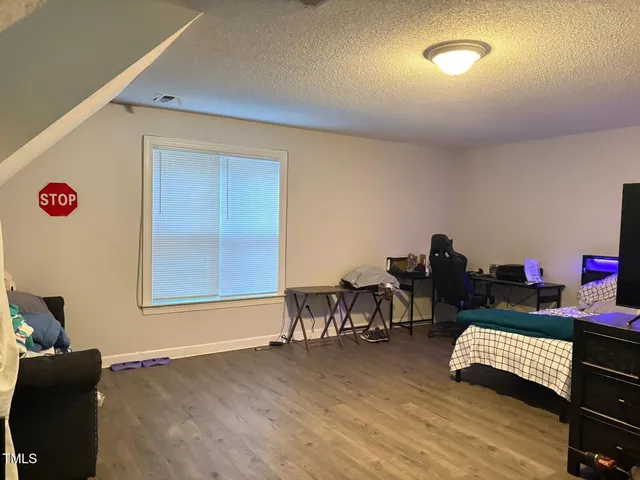 a bathroom with a granite countertop sink a toilet and shower
