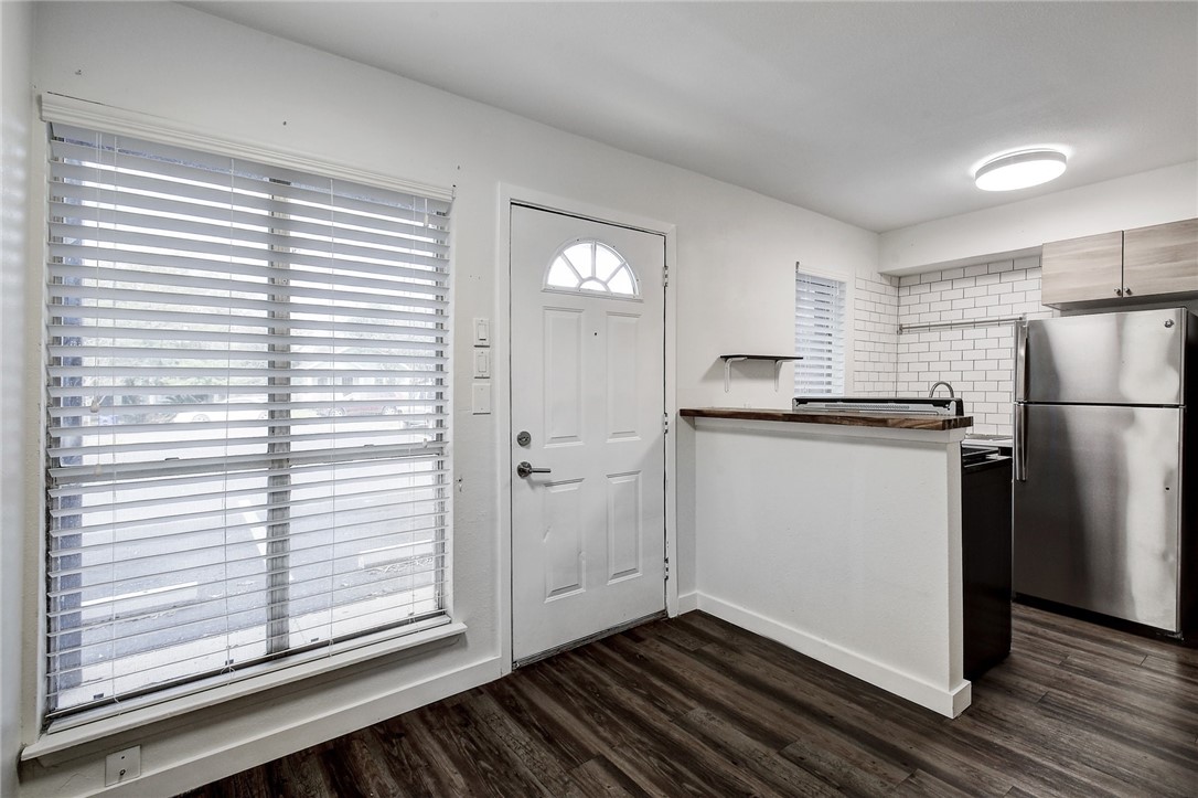 4111 Avenue A, Unit 108 Austin, TX 78751 - Photo 3 of 17 a kitchen with a refrigerator and white cabinets