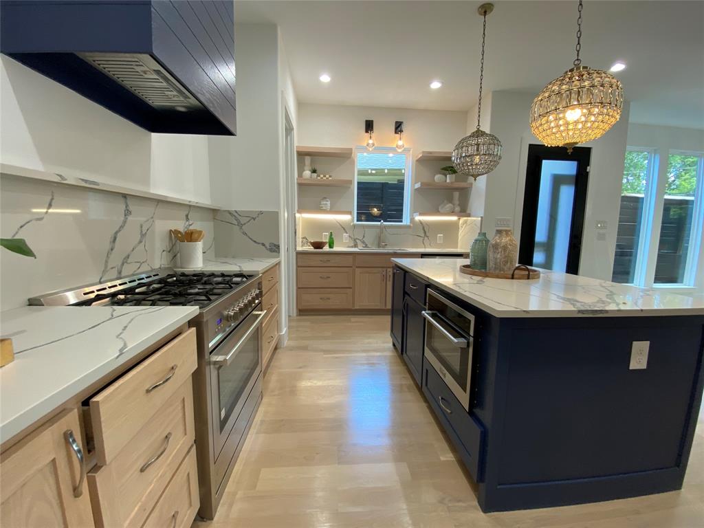 807 South Glasgow Drive Dallas, TX 75223 - Photo 5 of 25 a kitchen with stainless steel appliances granite countertop a sink a stove and a wooden floors