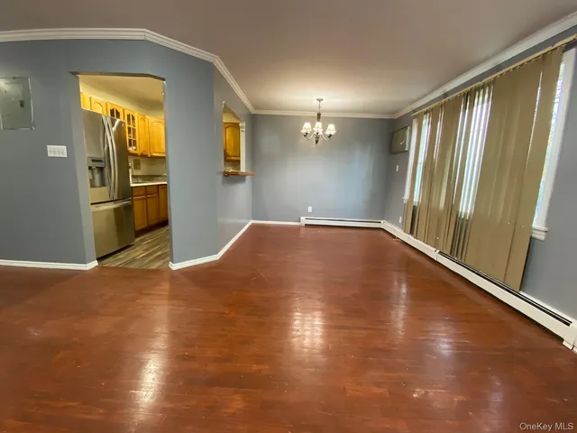 an empty room with wooden floor and sliding door