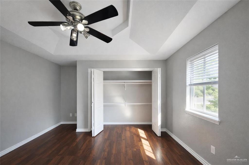 2115 East 29th Street Mission, TX 78574 - Photo 11 of 18 wooden floor in an empty room with a window