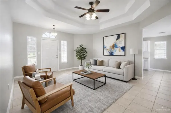 a living room with furniture and a chandelier