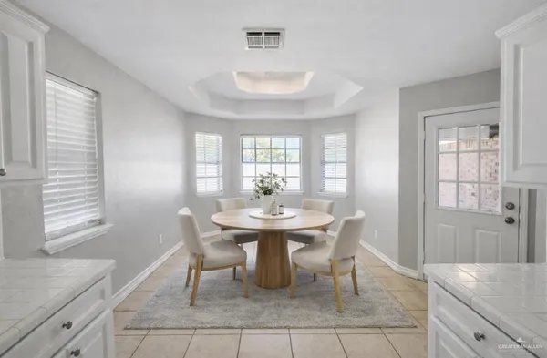 a dining room with furniture and window