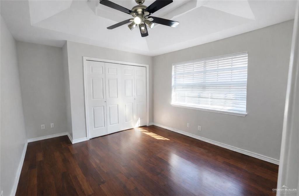 2115 East 29th Street Mission, TX 78574 - Photo 9 of 18 a view of an empty room with wooden floor and a window