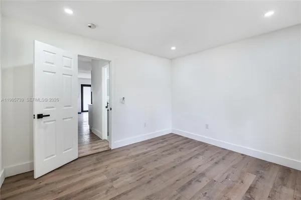 an empty room with wooden floor