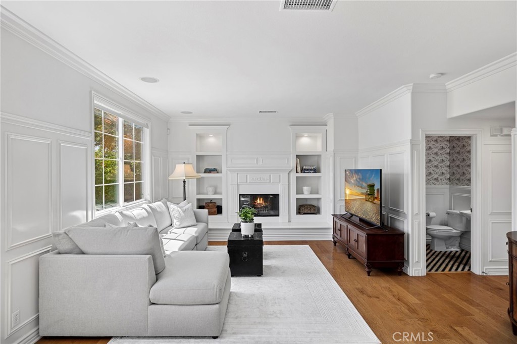 30 Baudin Circle Ladera Ranch, CA 92694 - Photo 19 of 75 a living room with furniture a fireplace and a flat screen tv