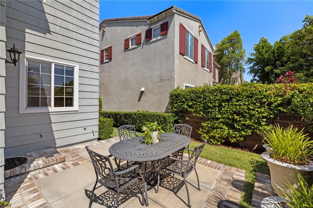 30 Baudin Circle Ladera Ranch, CA 92694 - Photo 41 of 75 a view of a table and chairs in back yard of the house
