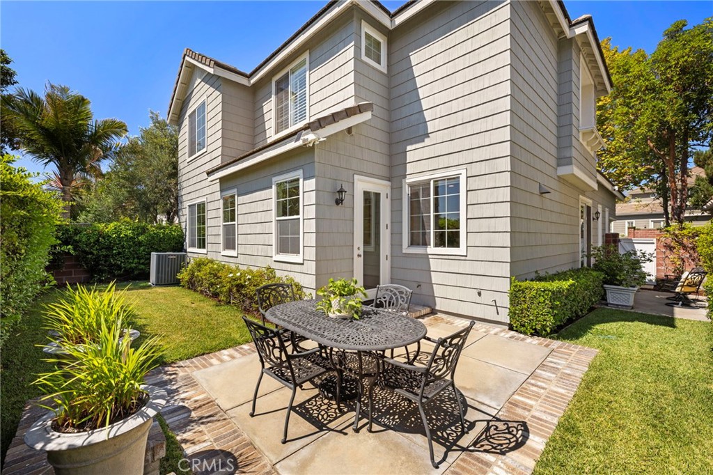 30 Baudin Circle Ladera Ranch, CA 92694 - Photo 5 of 75 a view of a patio with table and chairs potted plants and wooden fence