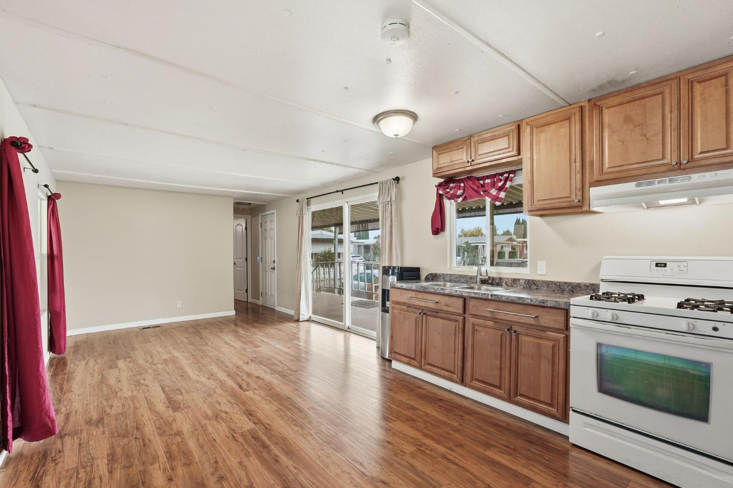 15820 Harlan Road, Unit 85 Lathrop, CA 95330 - Photo 11 of 27 a kitchen with stainless steel appliances granite countertop a stove and cabinets
