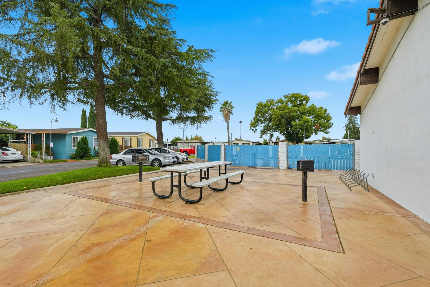 15820 Harlan Road, Unit 85 Lathrop, CA 95330 - Photo 23 of 27 a view of a backyard with table and chairs potted plants and a large tree