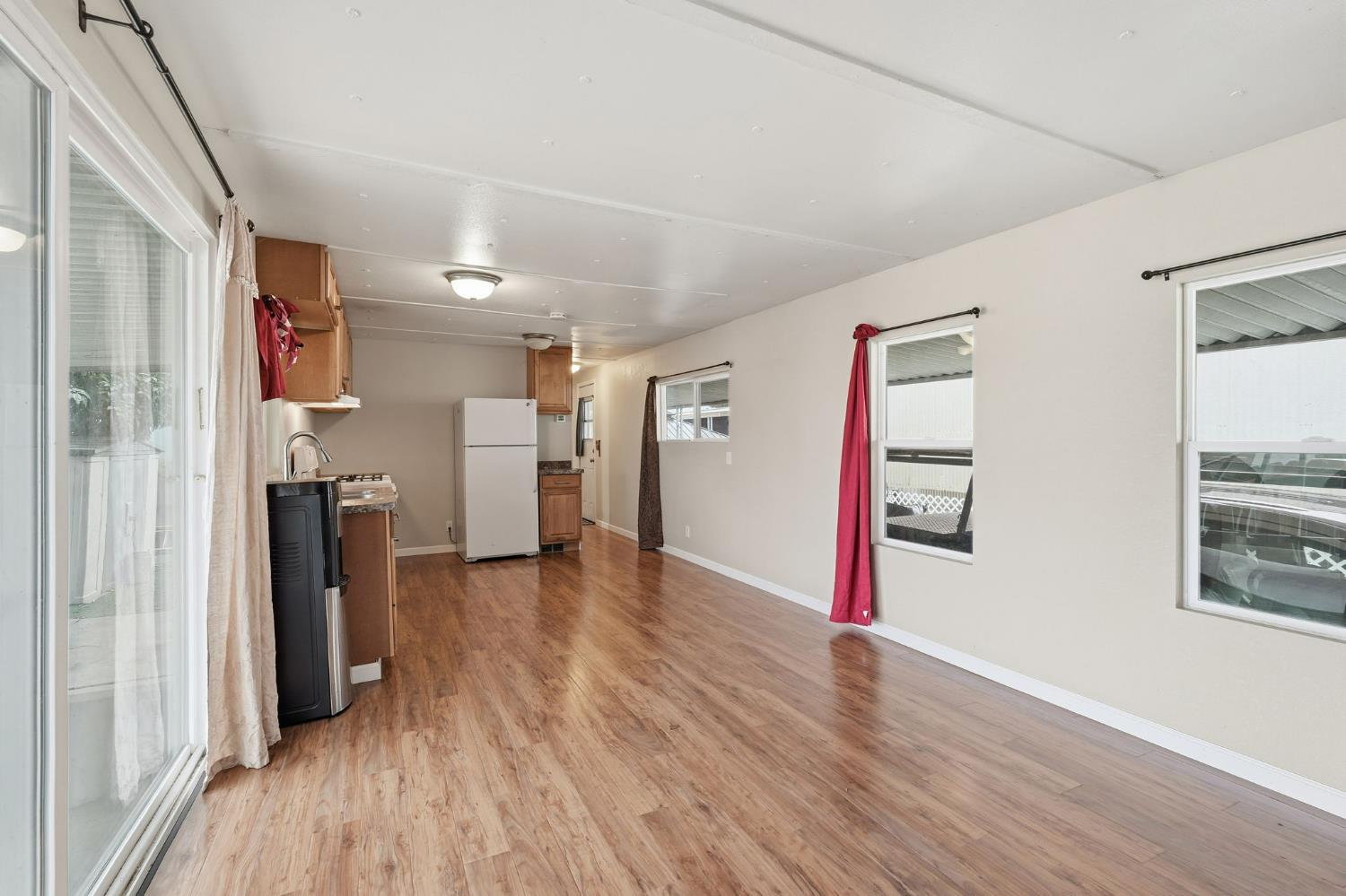 15820 Harlan Road, Unit 85 Lathrop, CA 95330 - Photo 7 of 27 a view of a hallway with wooden floor and closet