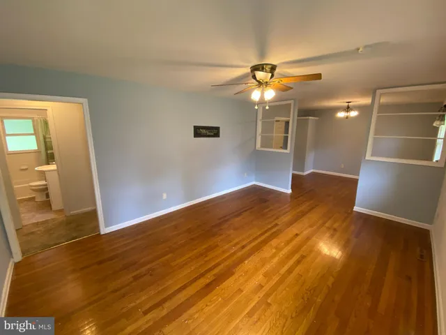 a view of empty room with wooden floor