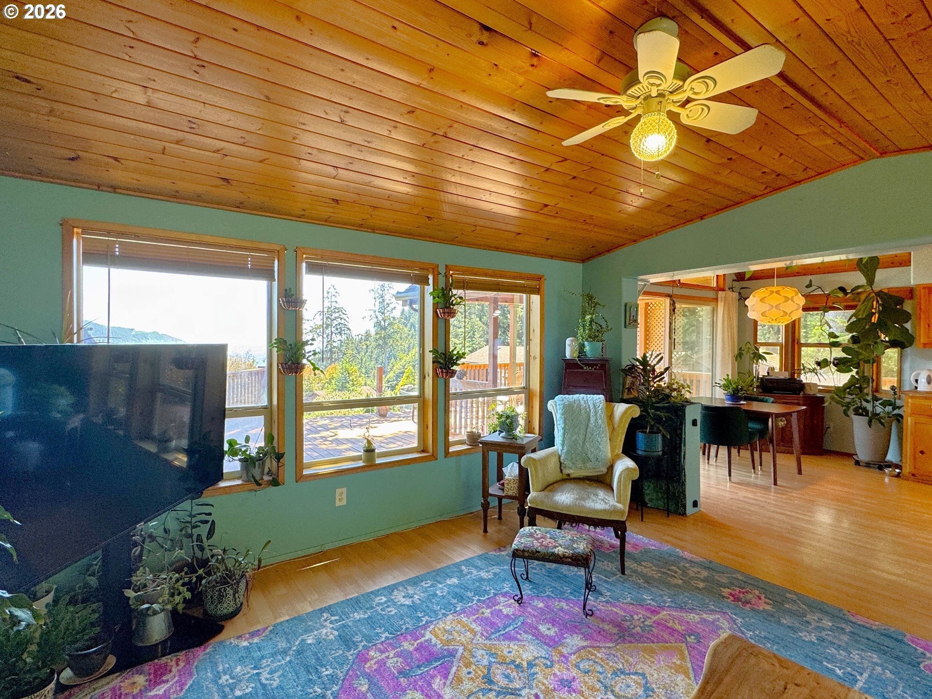 19921 Whaleshead Road, Unit U25 Brookings, OR 97415 - Photo 20 of 47 a living room with furniture a rug potted plant and a large window