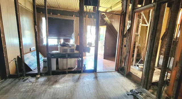 a view of a room with wooden floor and windows