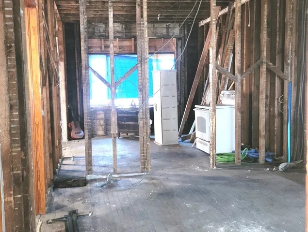 a bathroom with a granite countertop sink a mirror and shower