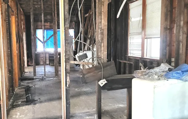 a view of a porch with furniture and floor to ceiling window