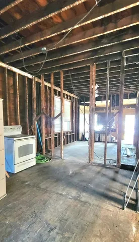 a view of a entryway door with hallway and wooden floor