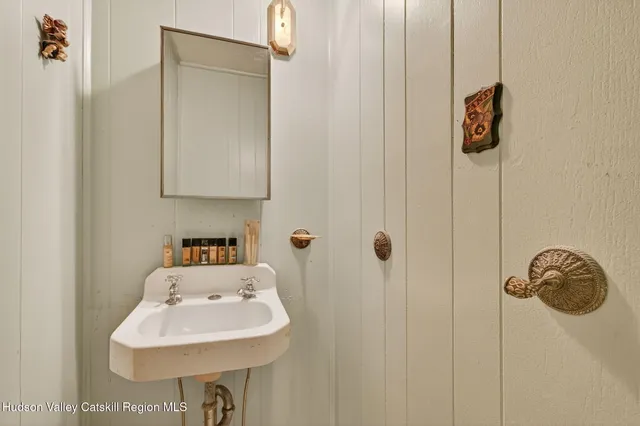 a bathroom with a sink a mirror and shower