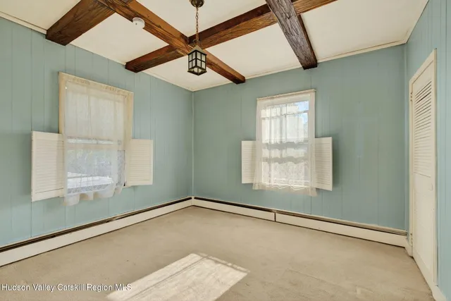 an empty room with a window and ceiling fan