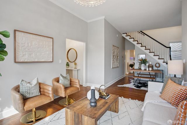 a living room with furniture and wooden floor