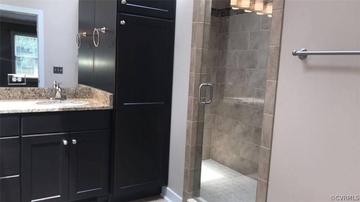 9120 Quail Ridge Road Chesterfield, VA 23832 - Photo 24 of 30 a bathroom with a granite countertop mirror and vanity
