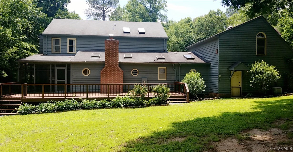 9120 Quail Ridge Road Chesterfield, VA 23832 - Photo 3 of 30 a front view of a house with a yard and garage