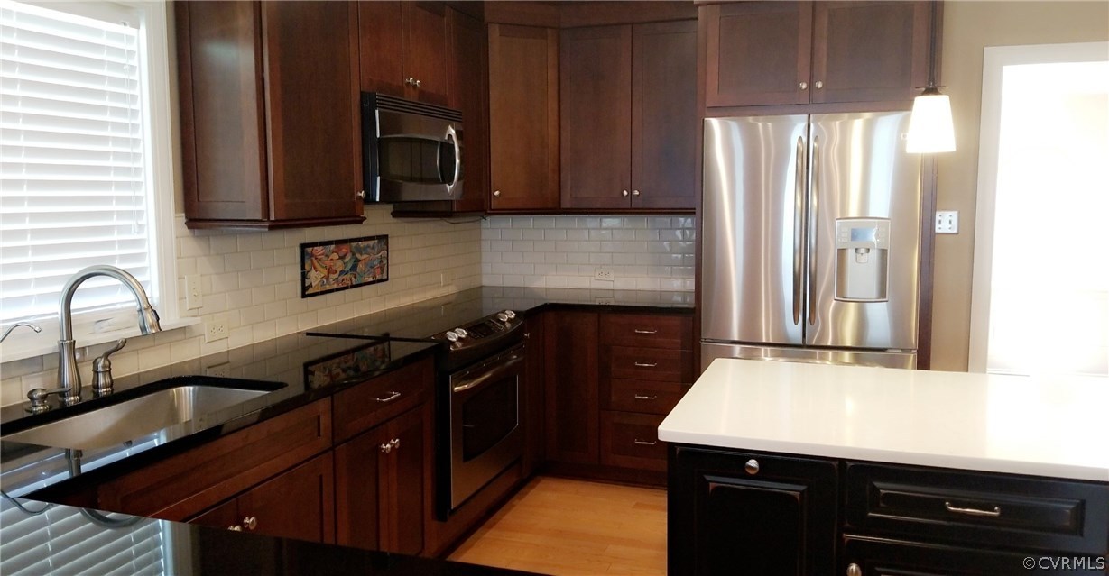9120 Quail Ridge Road Chesterfield, VA 23832 - Photo 8 of 30 a kitchen with granite countertop a sink stove and microwave