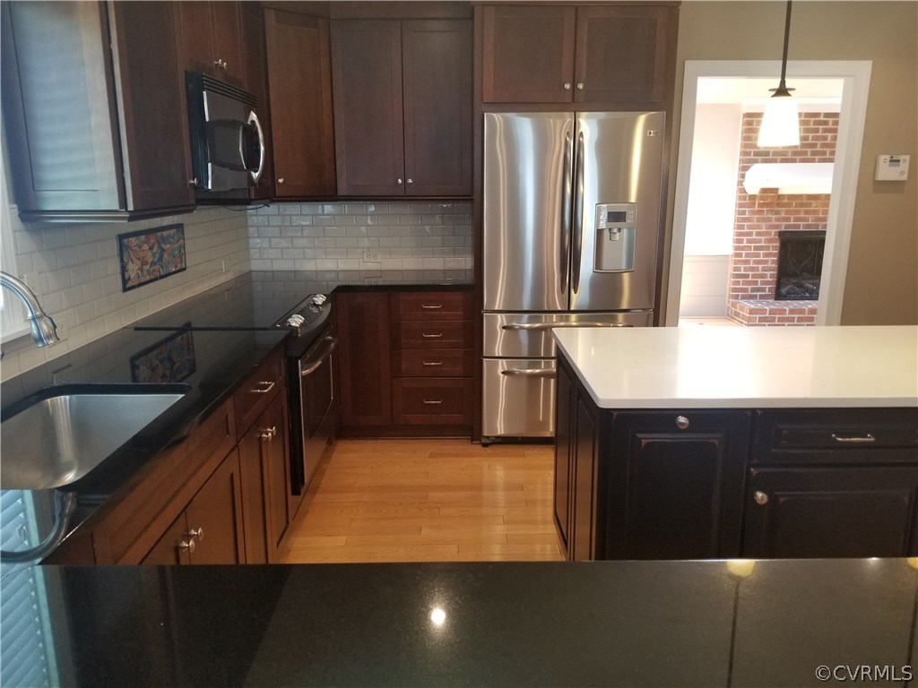 9120 Quail Ridge Road Chesterfield, VA 23832 - Photo 10 of 30 a kitchen with stainless steel appliances a sink stove and refrigerator
