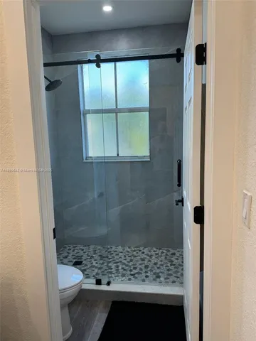 a bathroom with a shower and a toilet