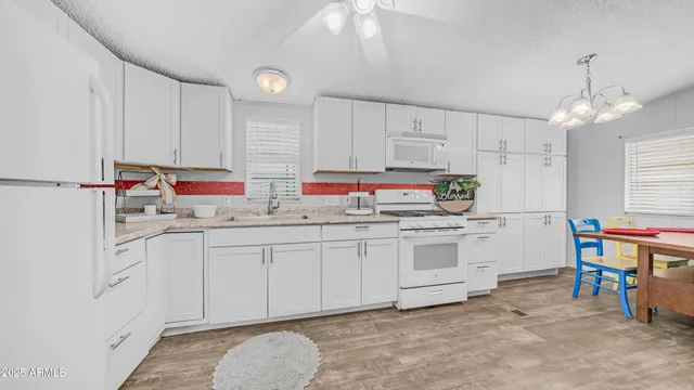 a kitchen that has a lot of cabinets in it and appliances