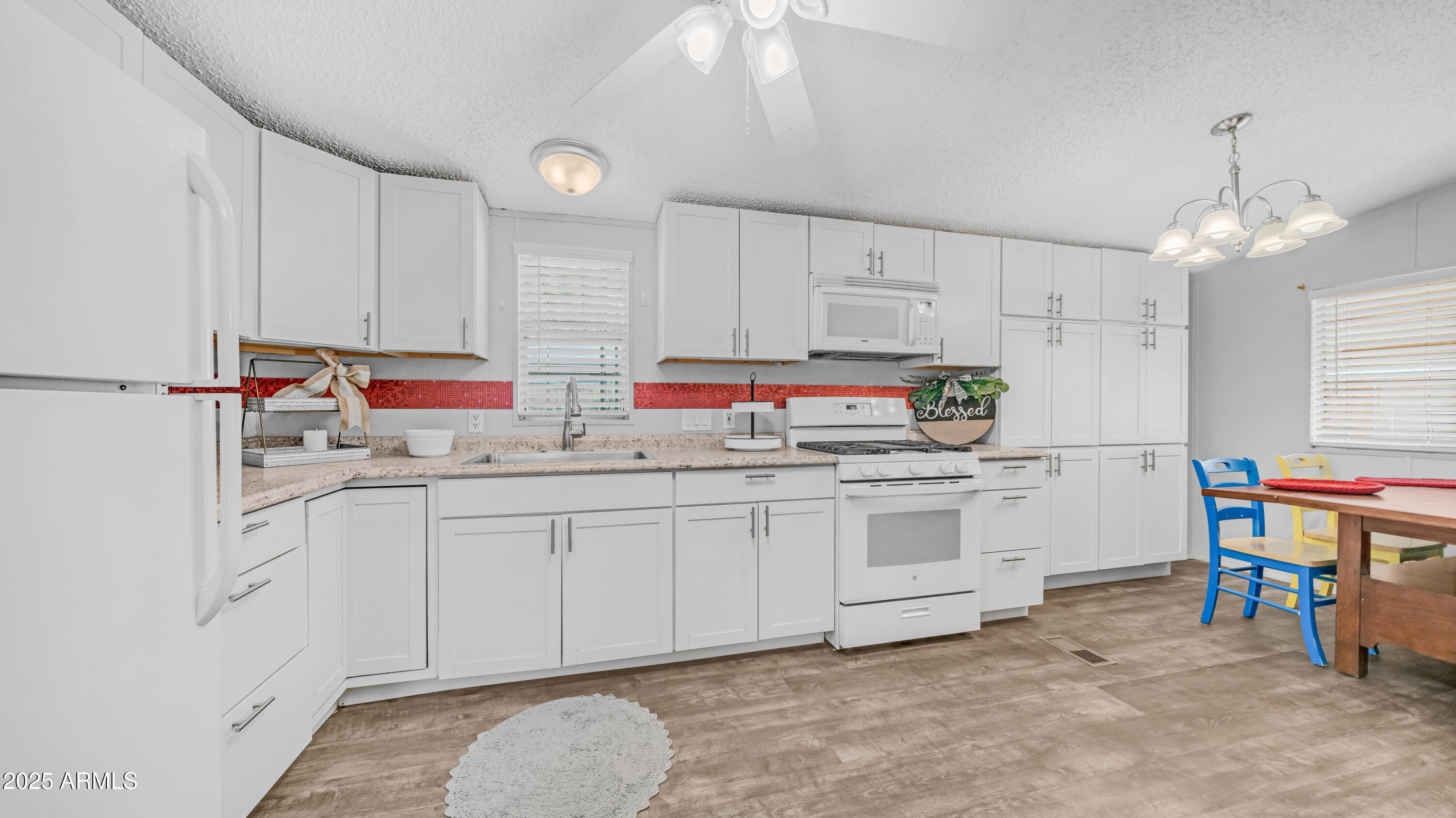 301 South Signal Butte Road, Unit 51 Apache Junction, AZ 85120 - Photo 1 of 32 a kitchen that has a lot of cabinets in it and appliances