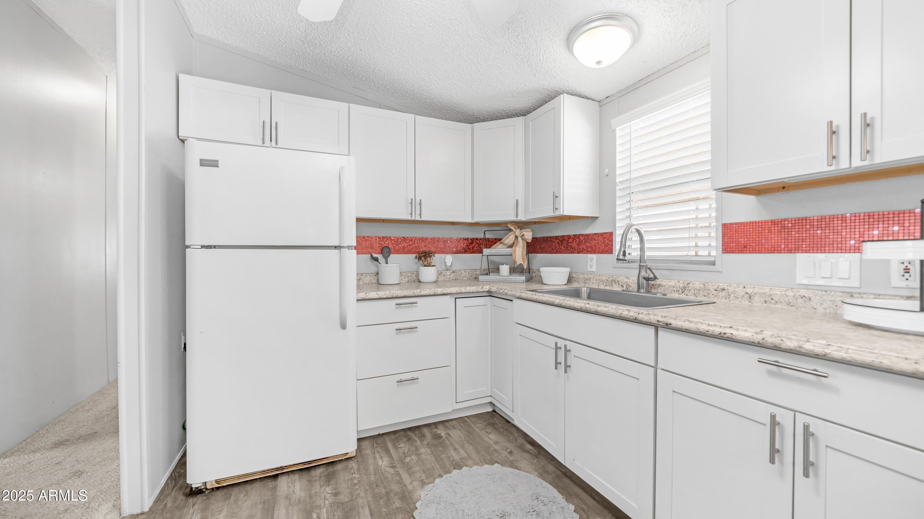 301 South Signal Butte Road, Unit 51 Apache Junction, AZ 85120 - Photo 14 of 32 a kitchen with cabinets appliances a sink and a window