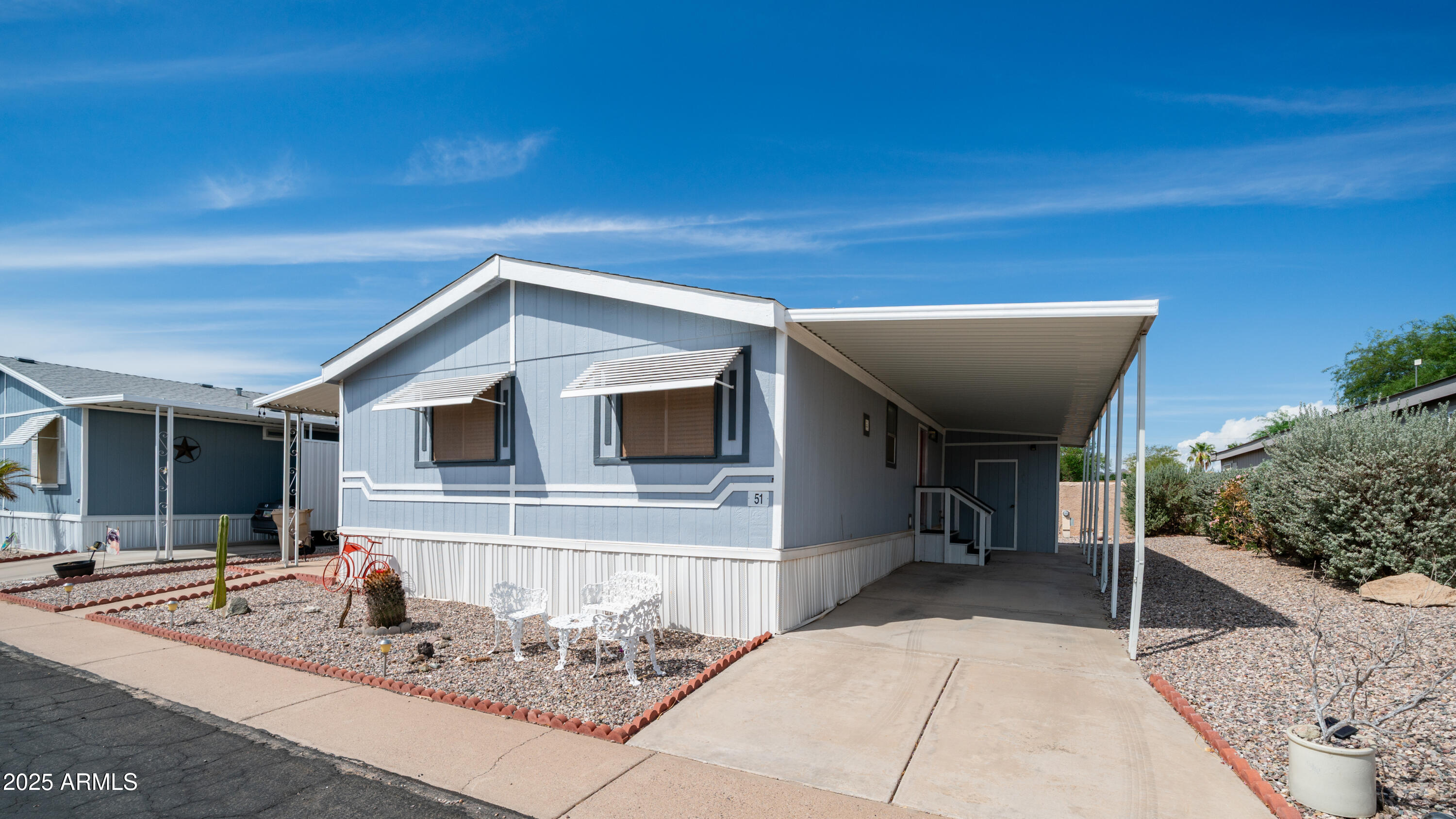 301 South Signal Butte Road, Unit 51 Apache Junction, AZ 85120 - Photo 2 of 32 a backyard of a house with seating space