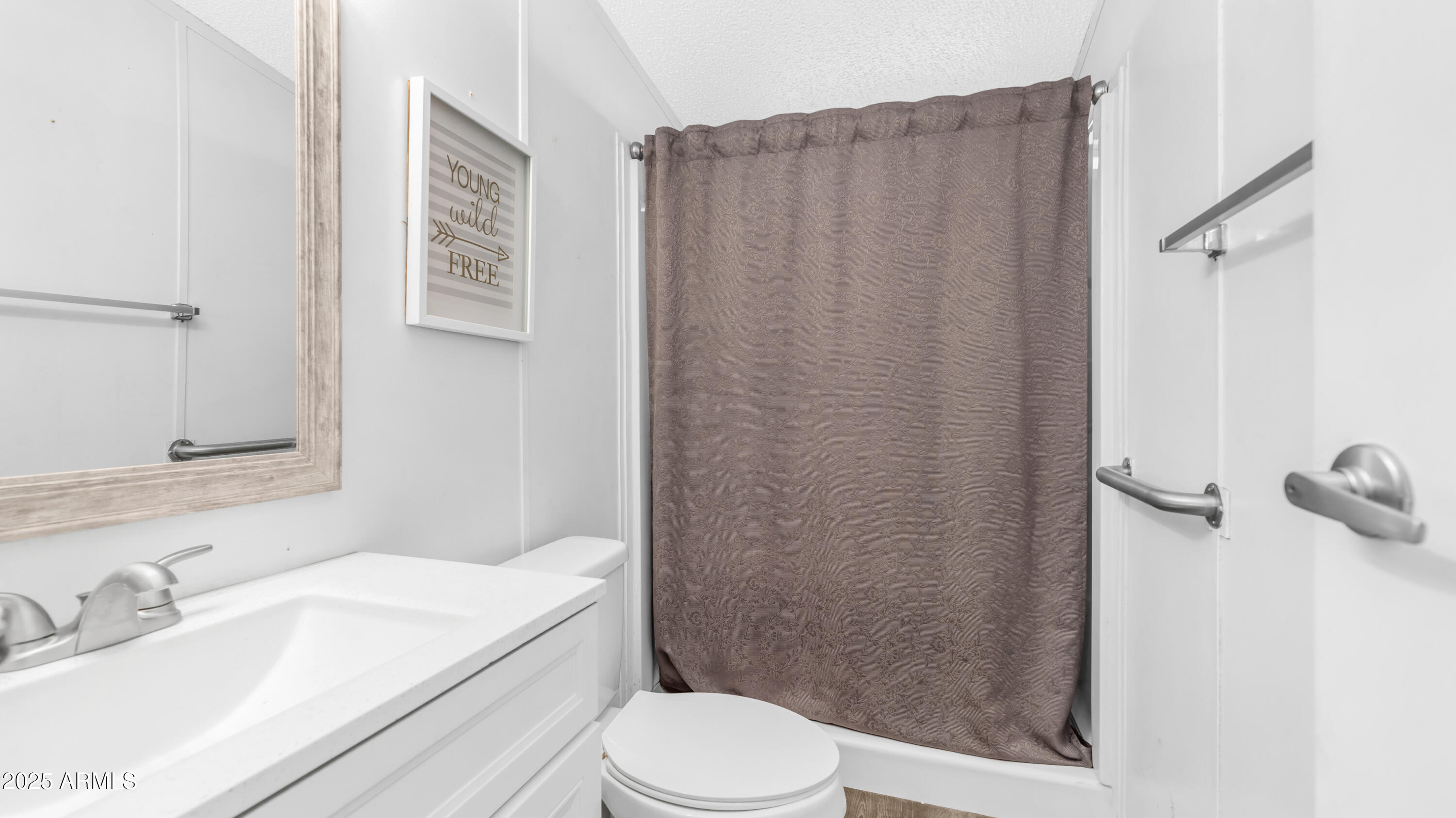 301 South Signal Butte Road, Unit 51 Apache Junction, AZ 85120 - Photo 22 of 32 a bathroom with a sink a toilet a shower and a mirror