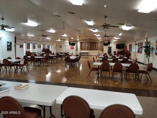 a room with pool table and windows
