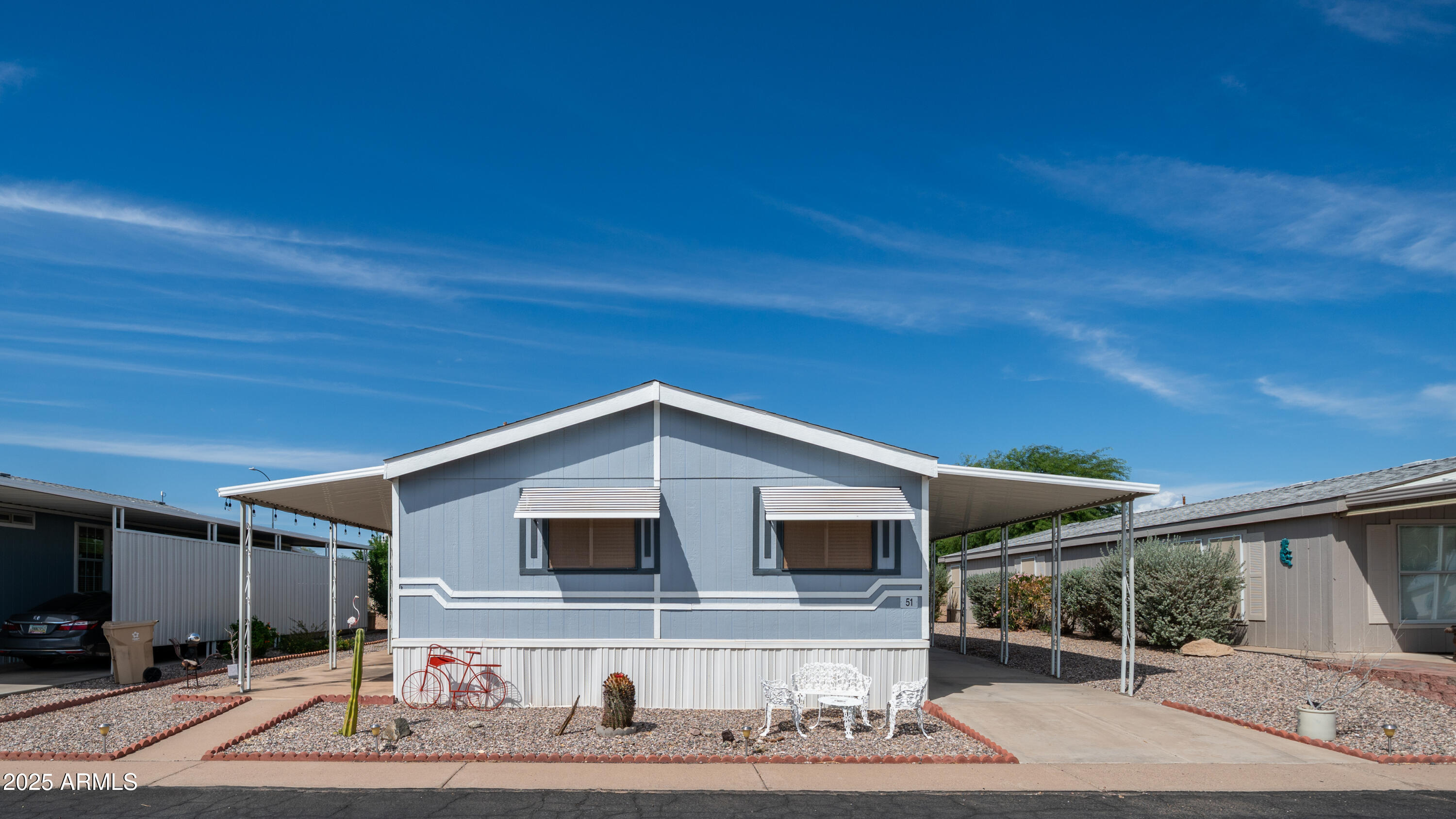 301 South Signal Butte Road, Unit 51 Apache Junction, AZ 85120 - Photo 4 of 32 a front view of a house with garden