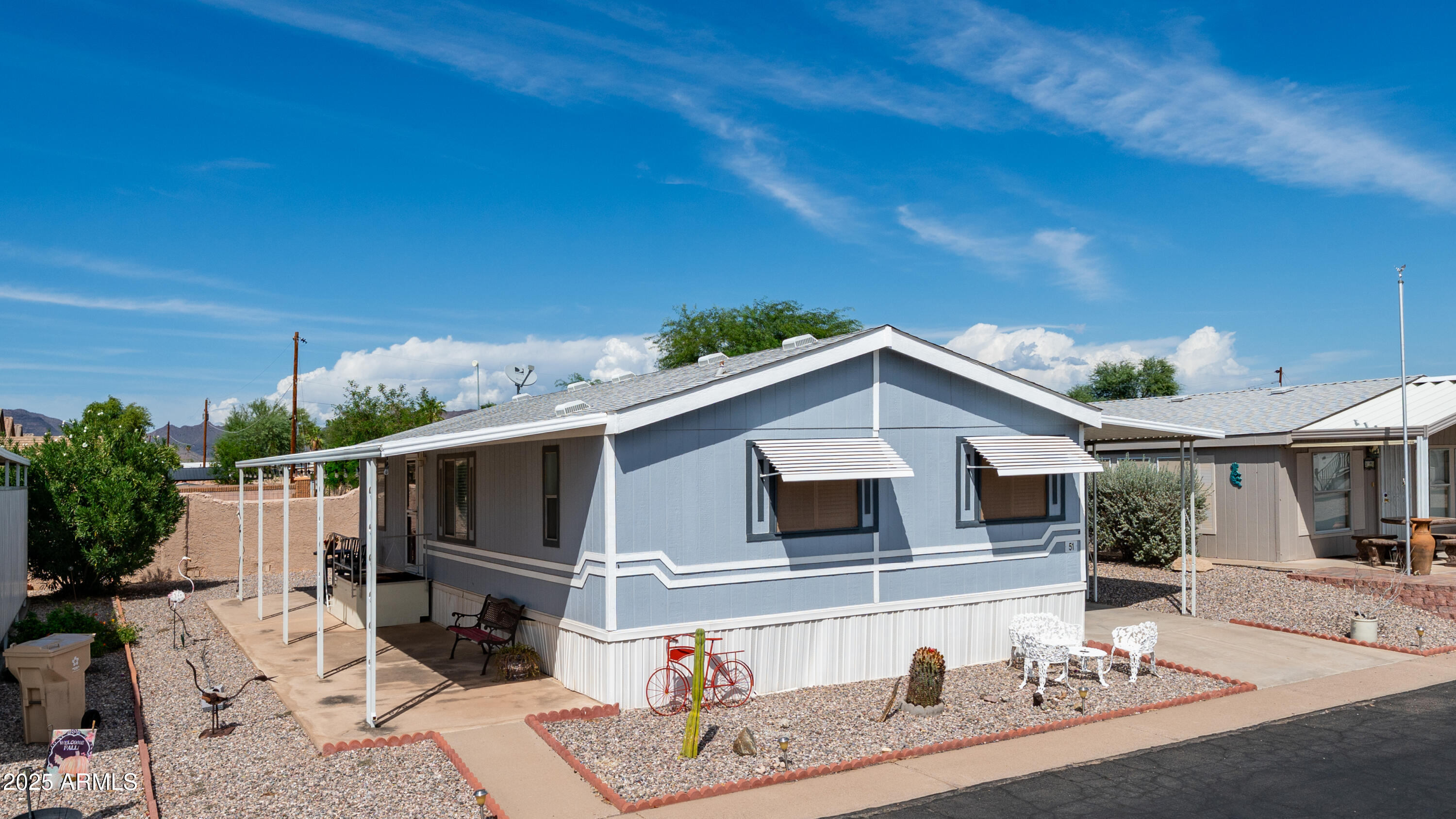 301 South Signal Butte Road, Unit 51 Apache Junction, AZ 85120 - Photo 6 of 32 a front view of a house with a yard