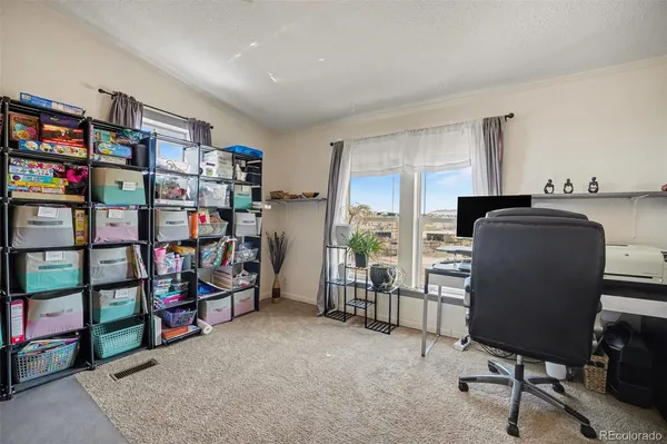a work room with furniture and a bookshelf