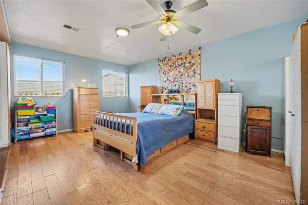 a bedroom with furniture and a baby crib